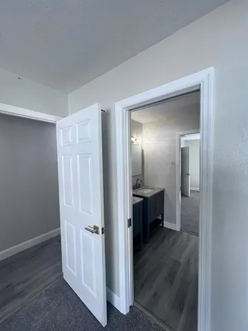 a view of hallway with wooden floor
