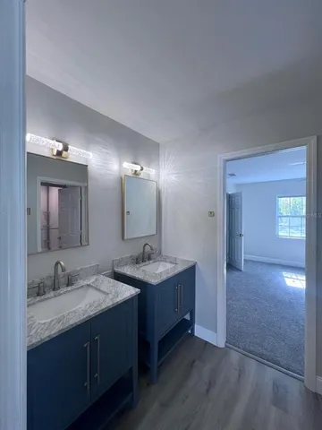 a bathroom with a double vanity sink and a mirror