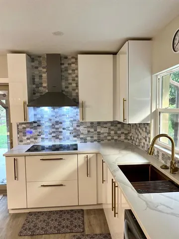 a kitchen with stainless steel appliances granite countertop a refrigerator sink and stove