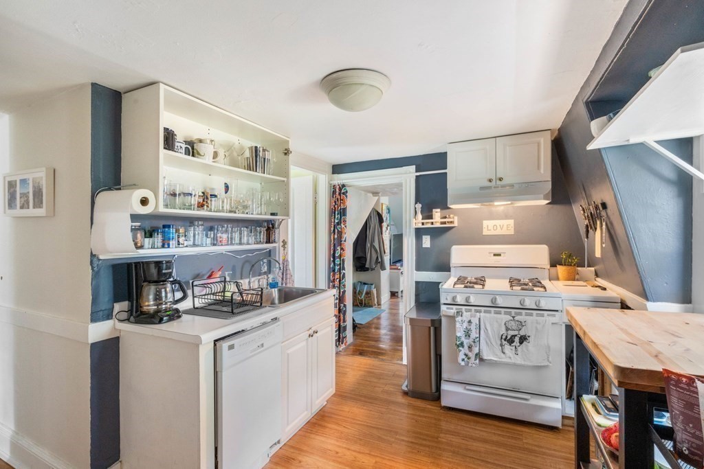 1298 Commonwealth Avenue Newton, MA 02468 - Photo 12 of 28 a kitchen with refrigerator and cabinets