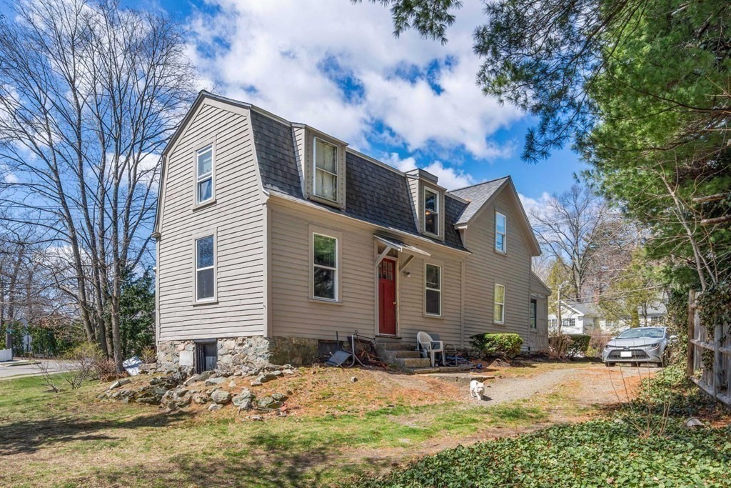 1298 Commonwealth Avenue Newton, MA 02468 - Photo 2 of 28 a front view of a house with a yard covered with snow