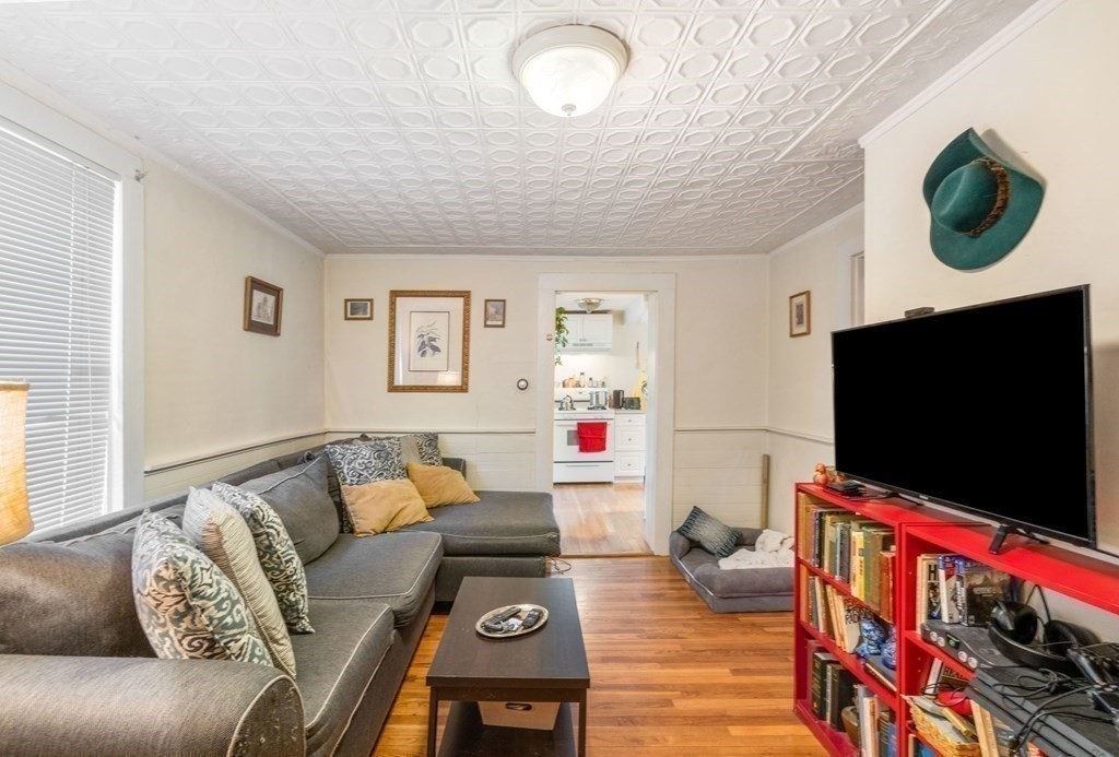 1298 Commonwealth Avenue Newton, MA 02468 - Photo 3 of 28 a living room with furniture and a flat screen tv