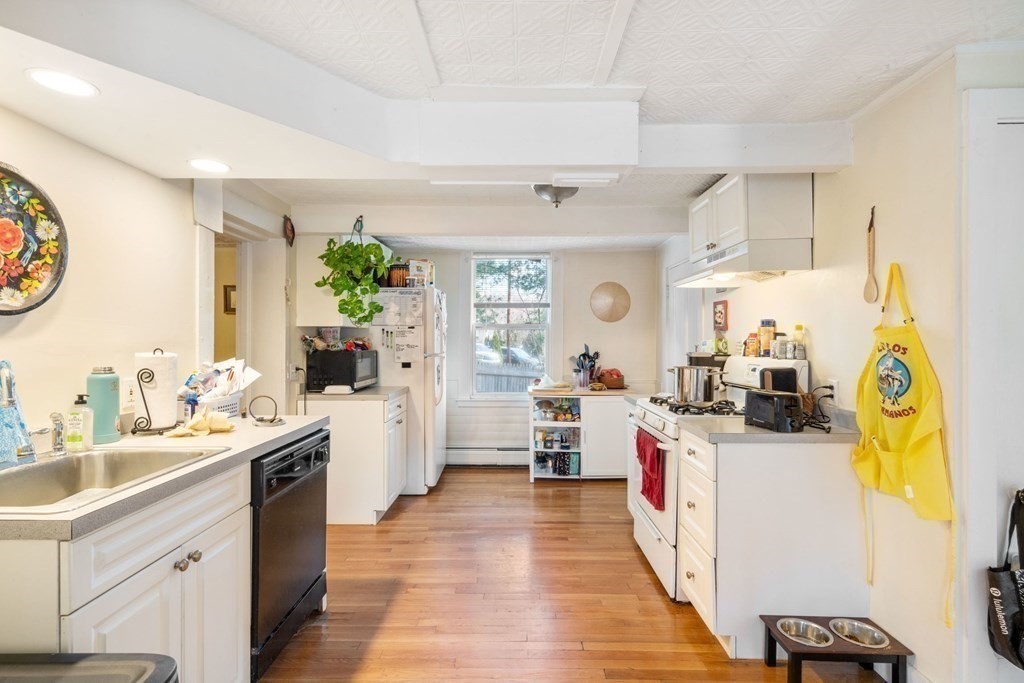1298 Commonwealth Avenue Newton, MA 02468 - Photo 5 of 28 a view of a kitchen with a sink cabinets and wooden floor