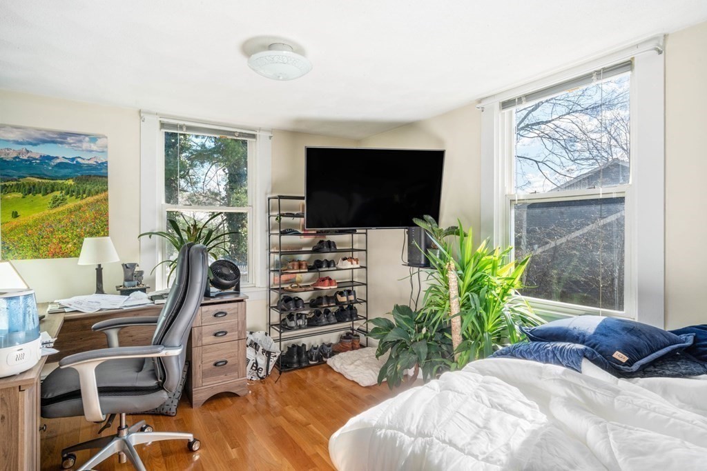 1298 Commonwealth Avenue Newton, MA 02468 - Photo 6 of 28 a bedroom with furniture and a flat screen tv