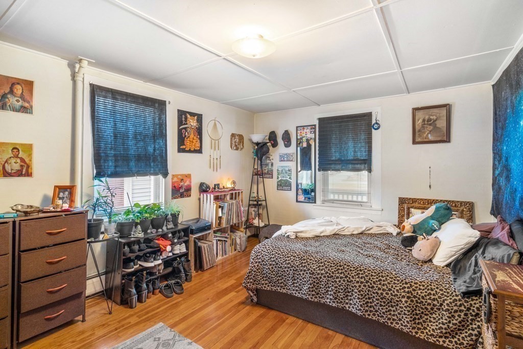 1298 Commonwealth Avenue Newton, MA 02468 - Photo 7 of 28 a bedroom with a bed and wooden floor