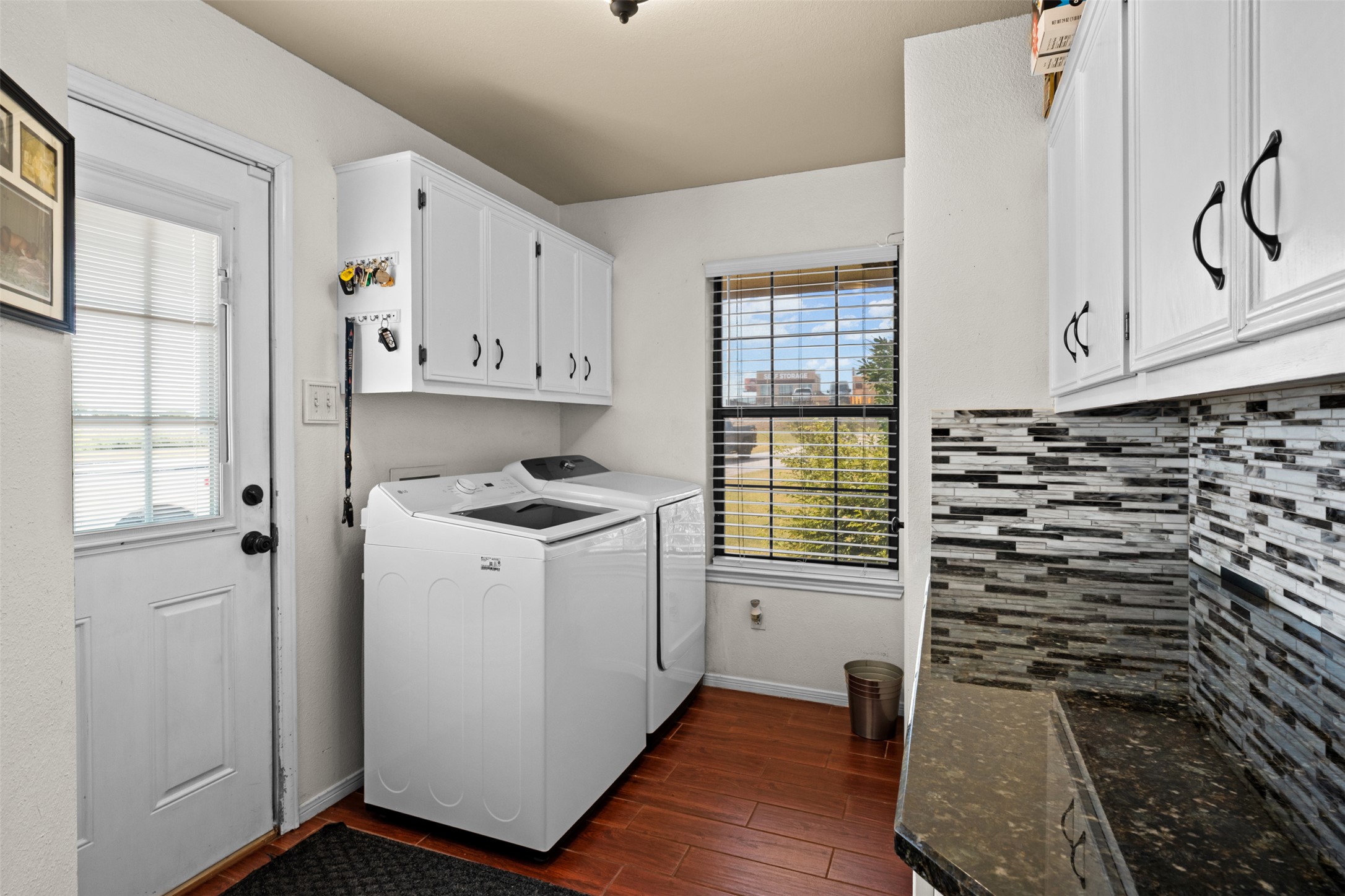 1512 Panther Loop Pflugerville, TX 78660 - Photo 27 of 40 A dedicated laundry space offers convenience with ample storage and a cheerful window view.
