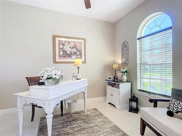 a spacious bedroom with a bed and a mirror on the dresser
