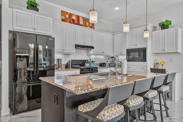a view of a house with pool and chairs