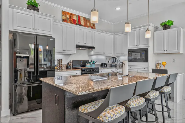 a view of a house with pool and chairs