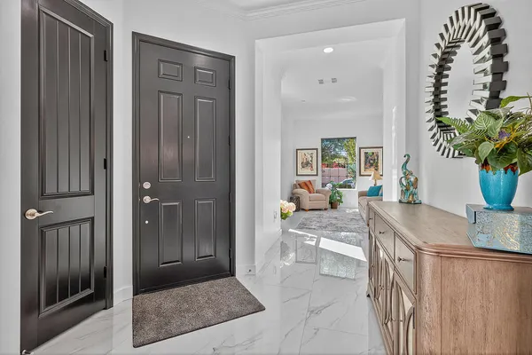 a kitchen with granite countertop kitchen island stainless steel appliances a sink a stove and refrigerator