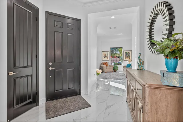 a kitchen with granite countertop kitchen island stainless steel appliances a sink a stove and refrigerator