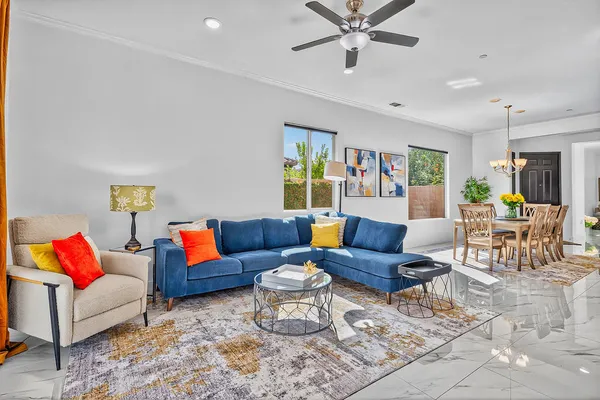 a view of a dining room with furniture a chandelier and wooden floor