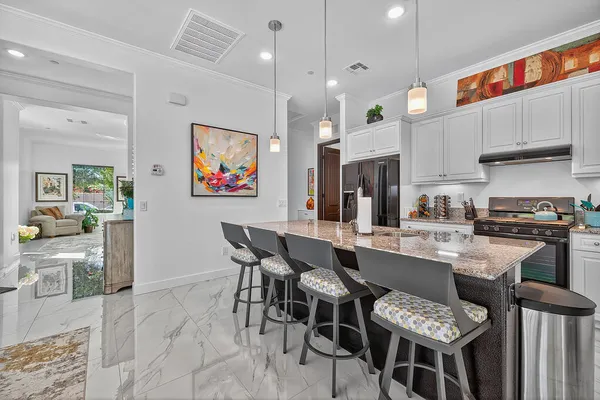 a bathroom with a granite countertop sink a mirror and a picture on the wall