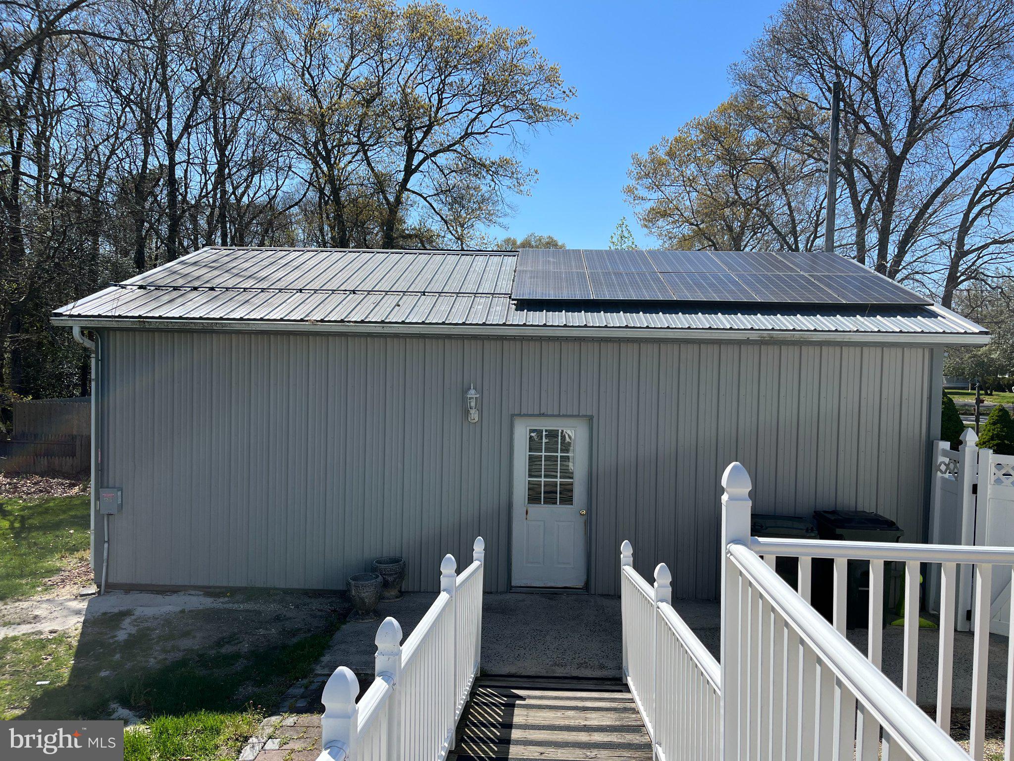 112 1st Avenue Tuckerton, NJ 08087 - Photo 6 of 42 Modern home with solar panels gleaming.