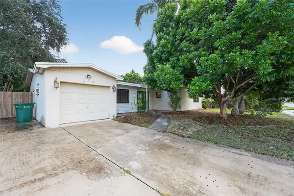 a view of a house with a yard and garage