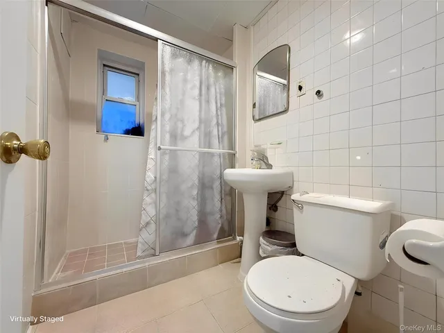 a white toilet sitting next to a bathroom sink