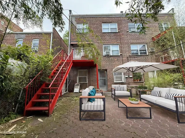 a backyard of a house with barbeque oven table and chairs