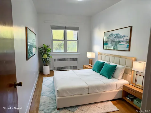 a bedroom with bed and a potted plant