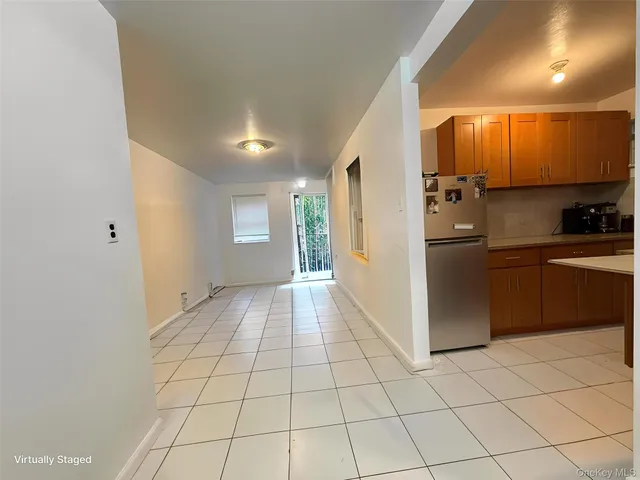 a view of a kitchen with an empty space and a window