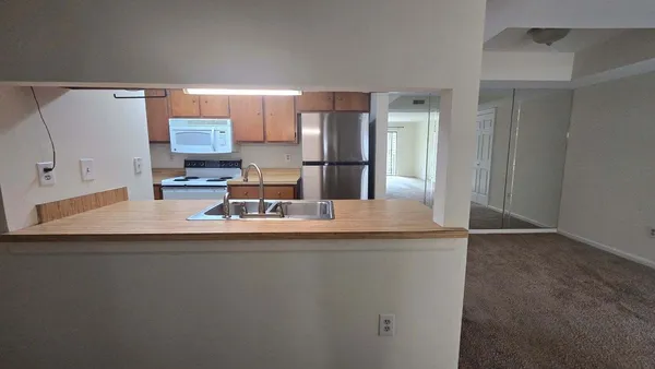 a kitchen with kitchen island a sink and a refrigerator