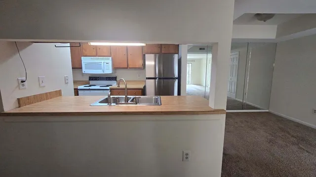 a kitchen with kitchen island a sink and a refrigerator