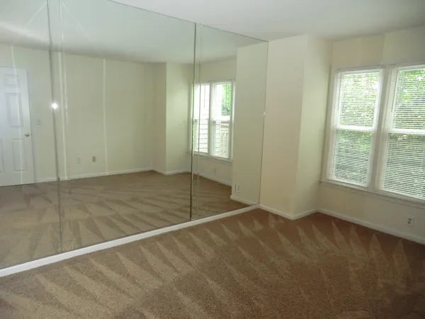 a view of an empty room with glass door