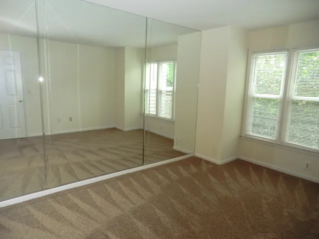 a view of an empty room with glass door