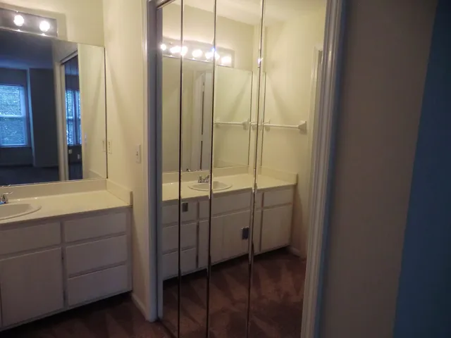 a bathroom with a glass shower door and a sink