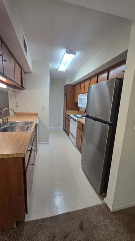 a kitchen with stainless steel appliances a refrigerator and a sink
