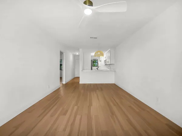 a view of a room with wooden floor