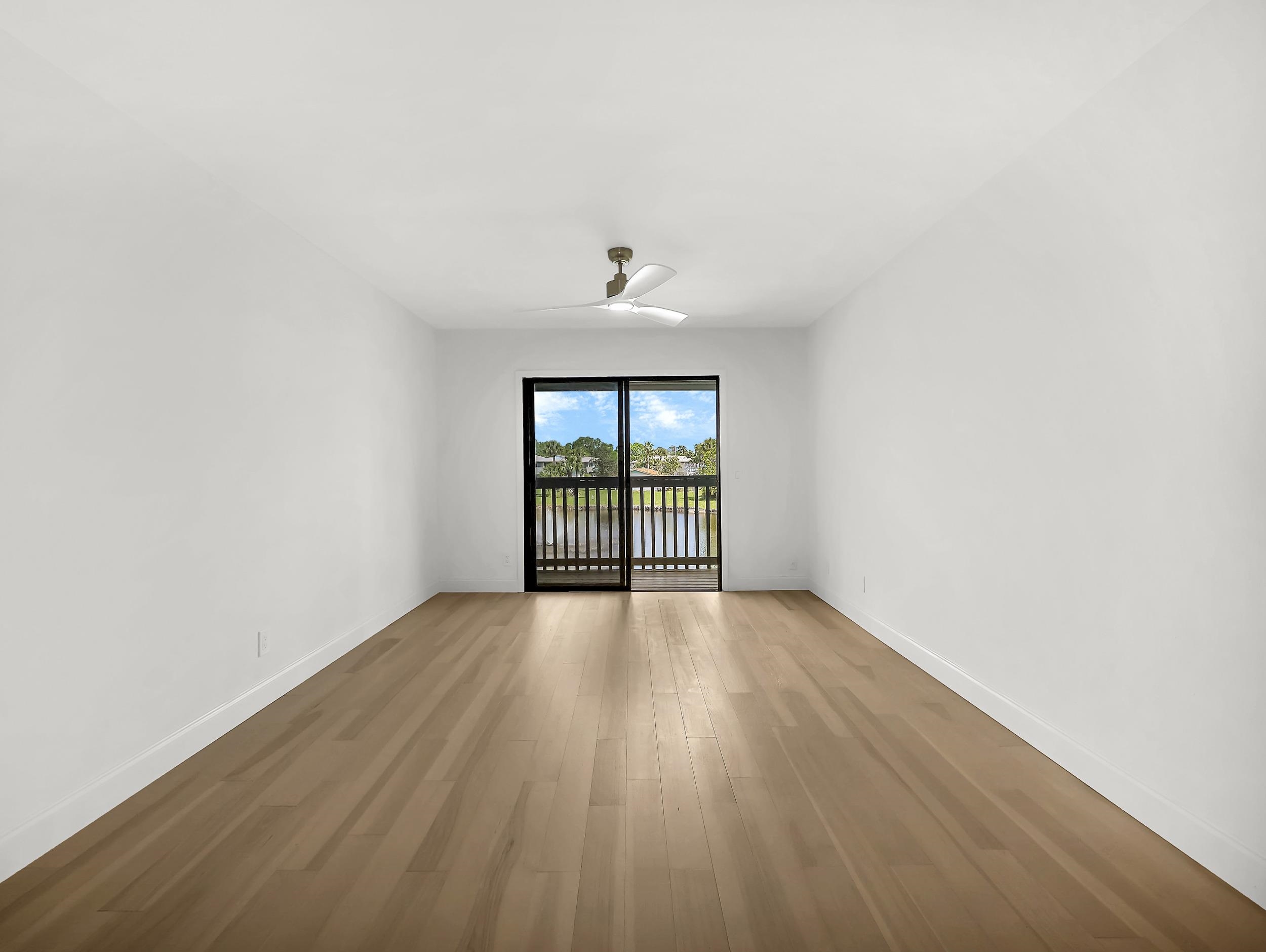 650 West Pope Road, Unit 218 St. Augustine, FL 32080 - Photo 13 of 30 an empty room with wooden floor and windows