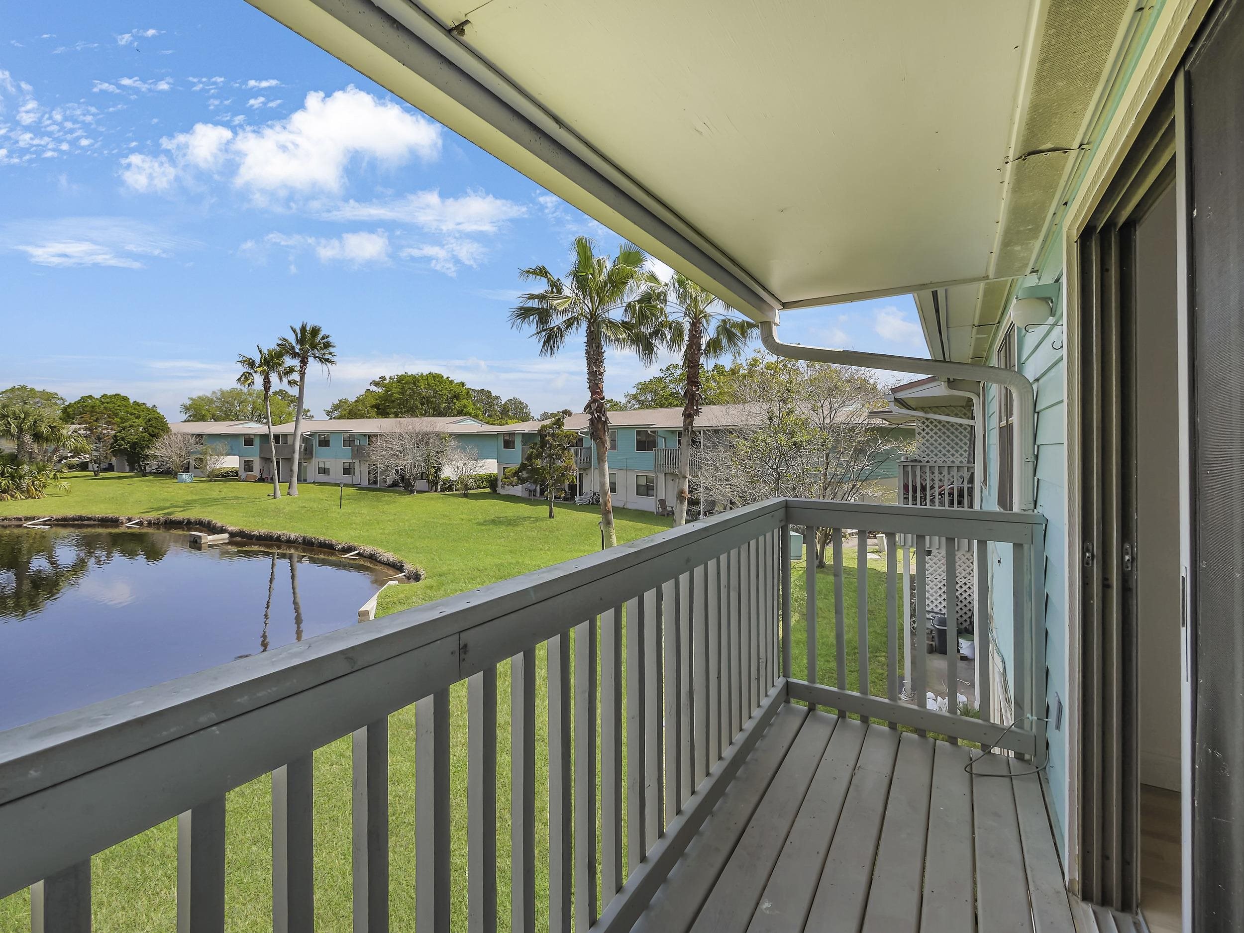 650 West Pope Road, Unit 218 St. Augustine, FL 32080 - Photo 14 of 30 a view of a balcony with wooden floor & fence