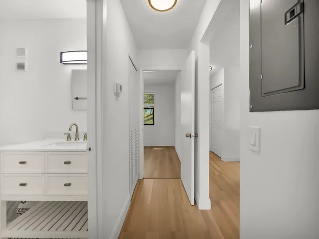 a view of hallway with wooden floor