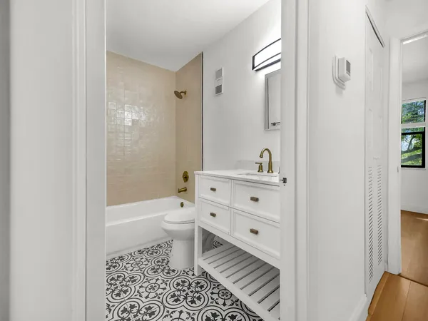 a bathroom with a toilet a sink and a bathtub