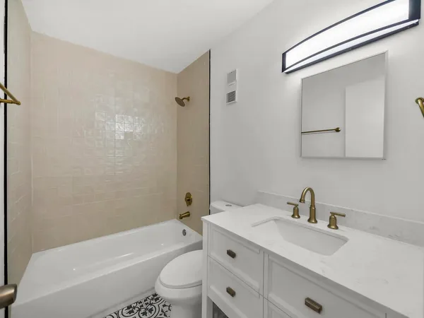 a bathroom with a sink toilet a mirror and shower