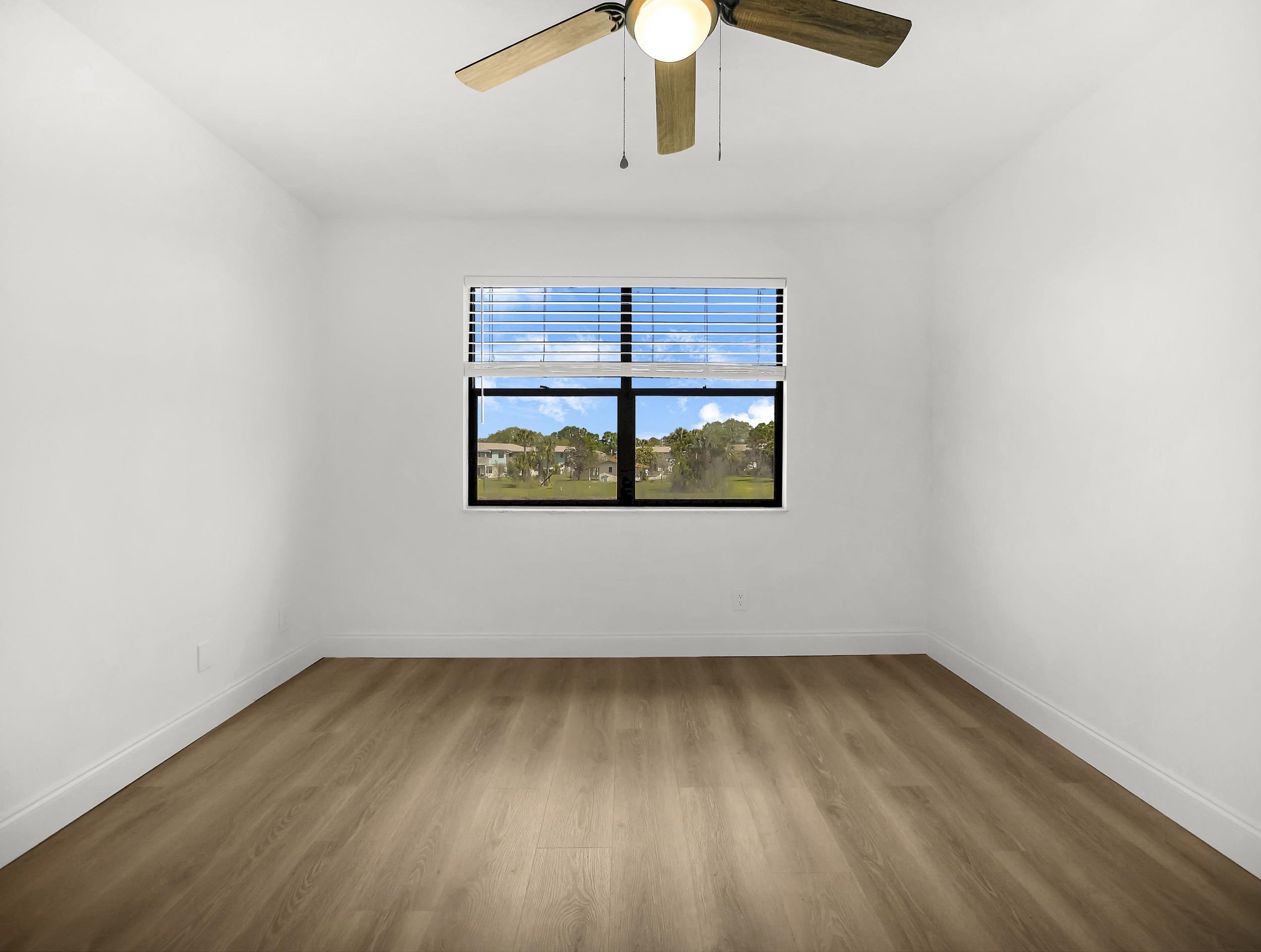650 West Pope Road, Unit 218 St. Augustine, FL 32080 - Photo 24 of 30 an empty room with wooden floor and windows