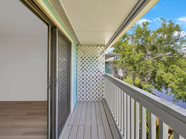 a view of a balcony with wooden floor