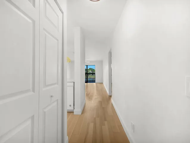 a view of a hallway with wooden floor