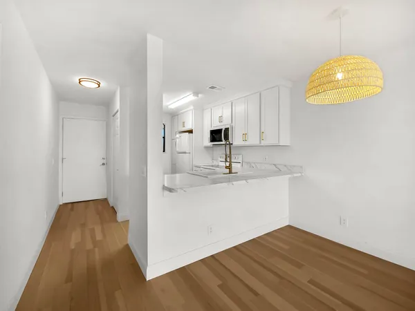 a view of a kitchen with wooden floor