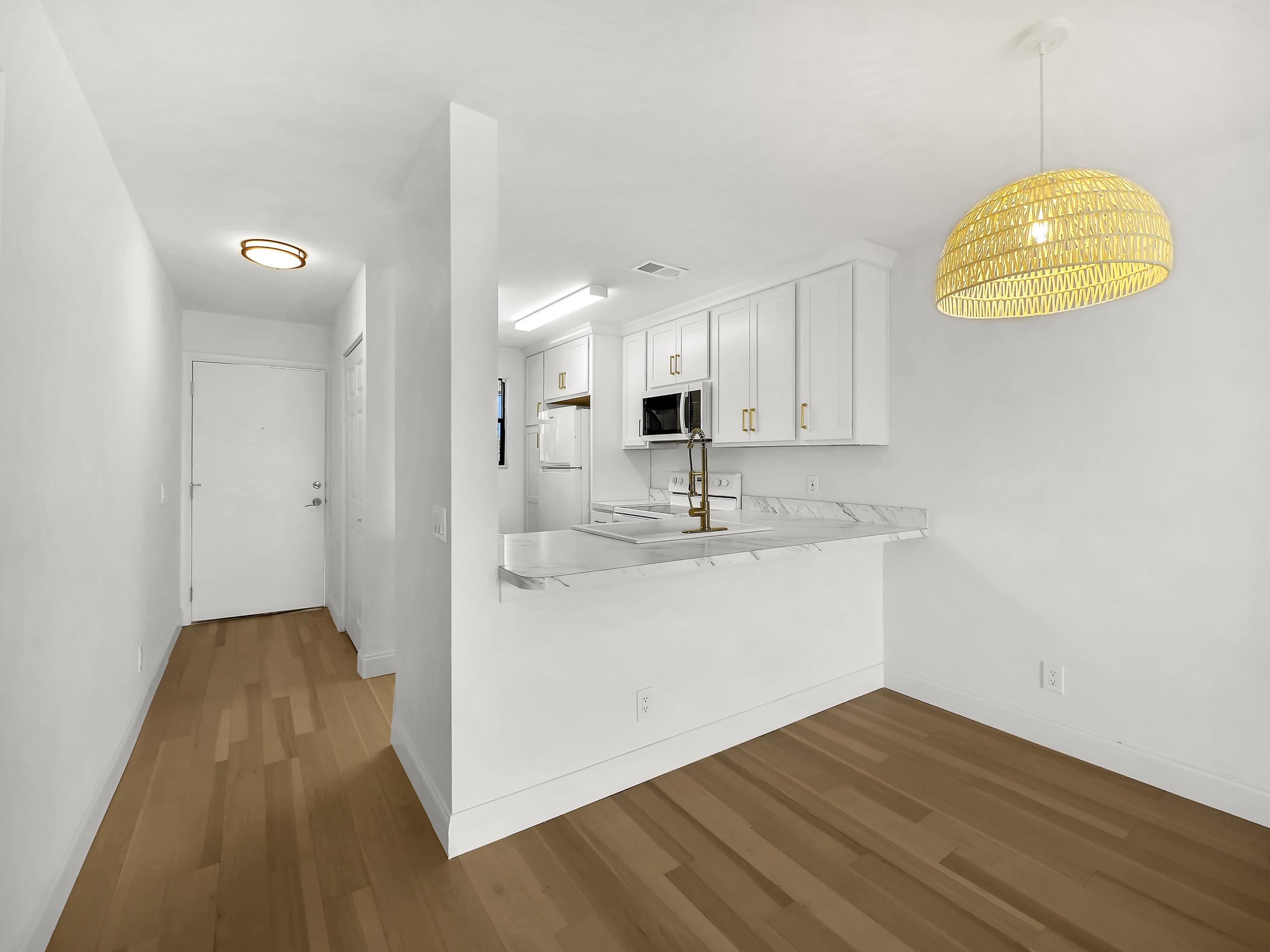 650 West Pope Road, Unit 218 St. Augustine, FL 32080 - Photo 9 of 30 a view of a kitchen with wooden floor