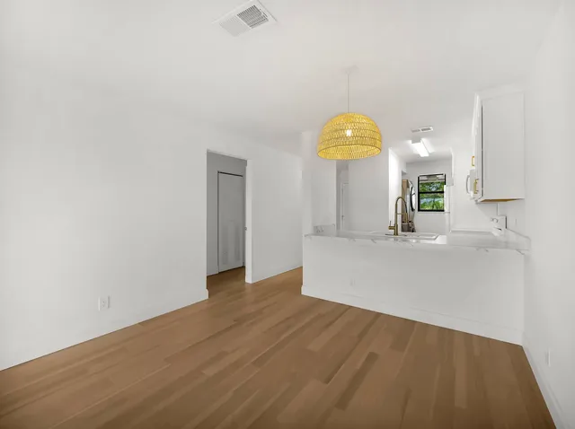 a view of a kitchen with a sink and a window