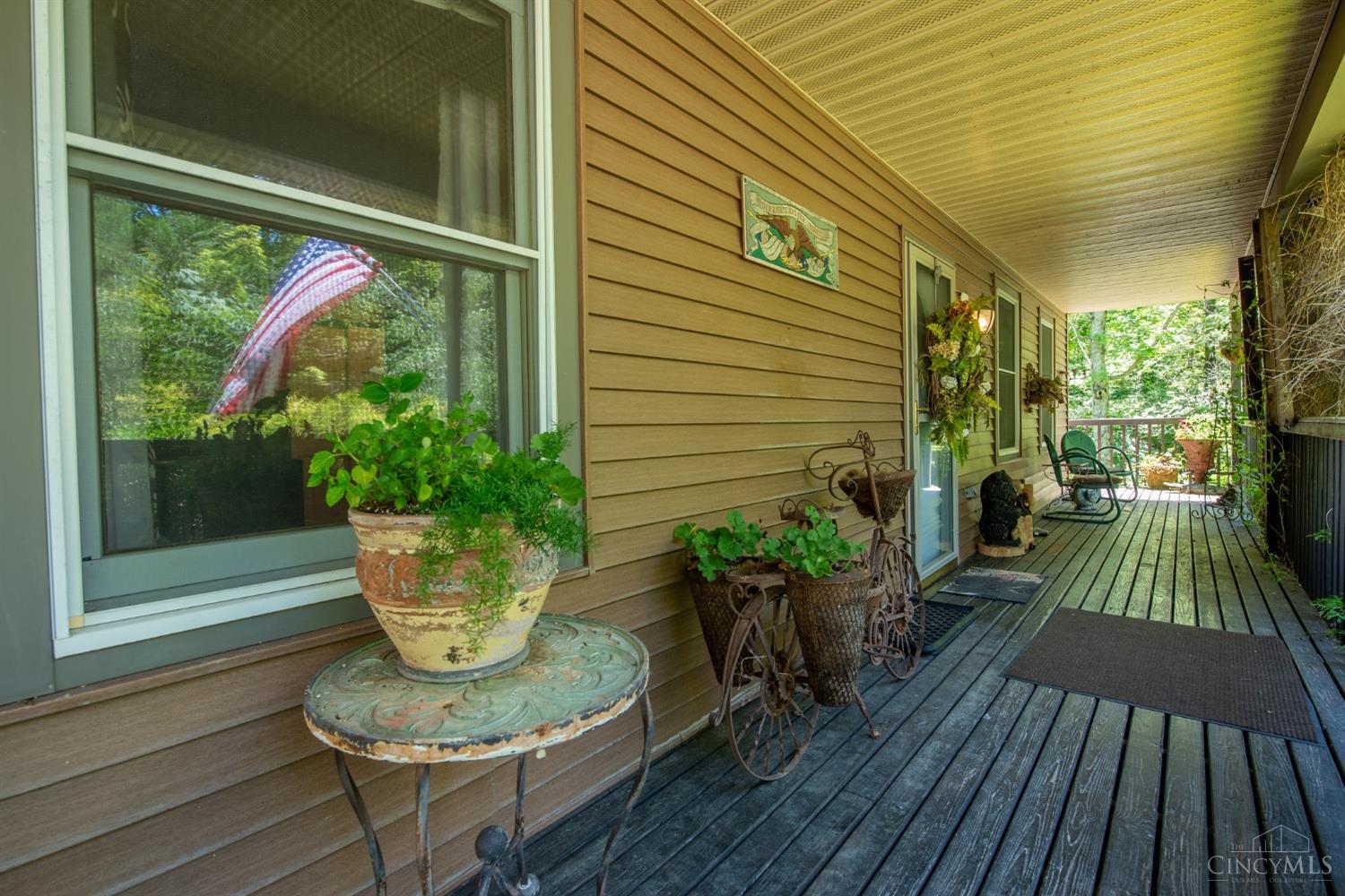 Covered Front Porch Which Wraps Around the Side of the Home to the Back Deck