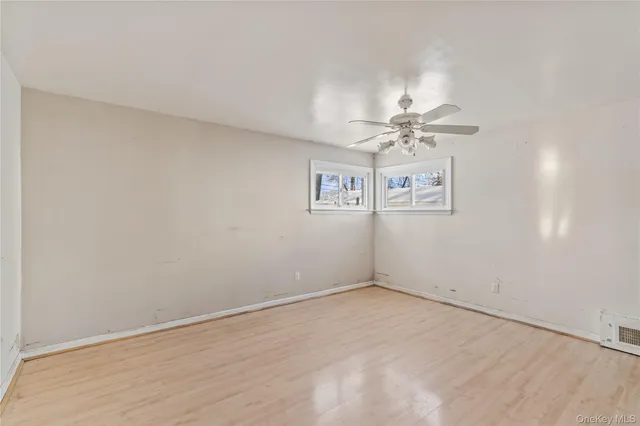 a view of a room with a fan & a window