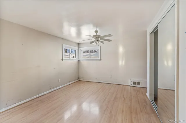 a view of a room with wooden floor and white walls