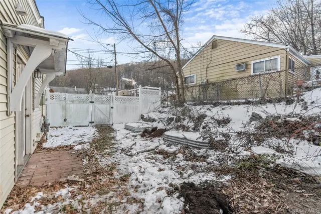 a view of a house with a yard covered in snow