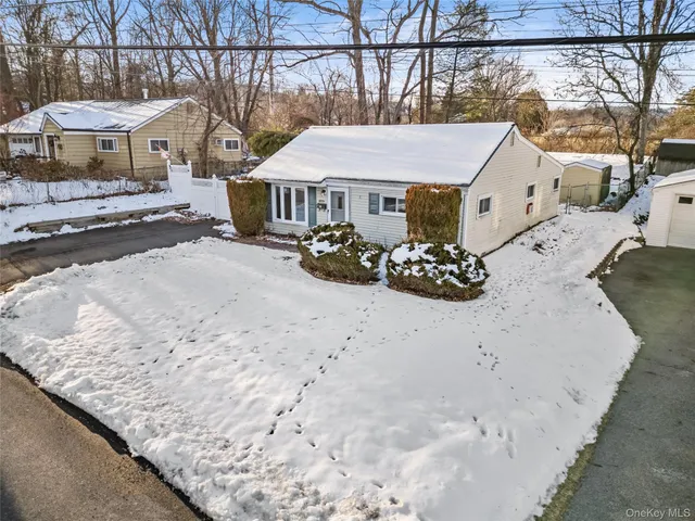 a view of a house with a snow in the yard