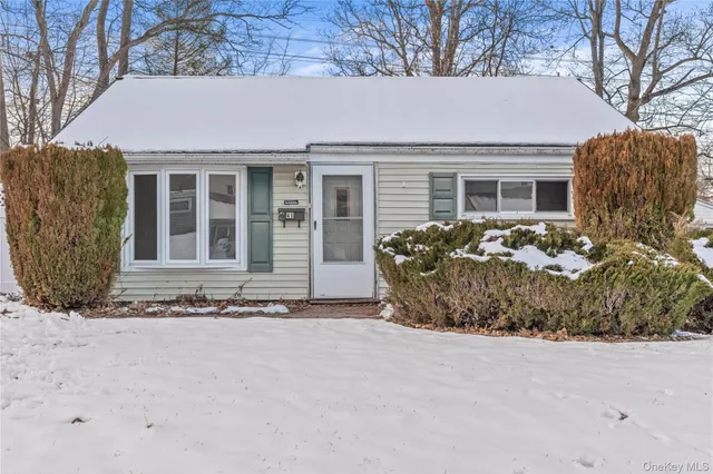 a view of a house with snow in the yard