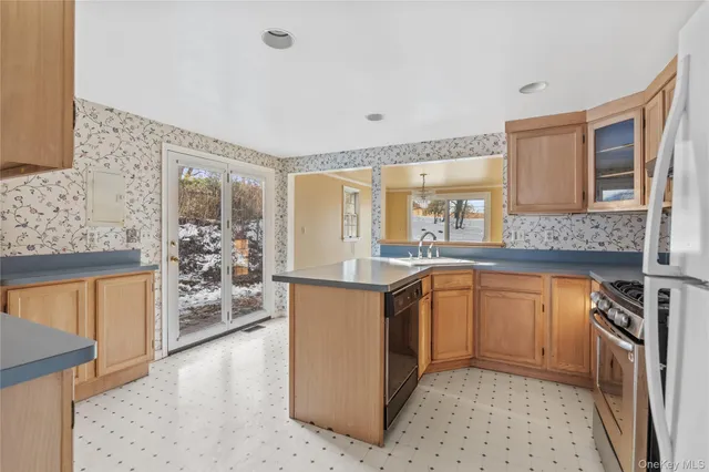 a kitchen with stainless steel appliances granite countertop a stove a sink and a refrigerator