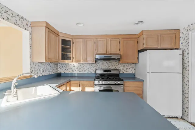 a kitchen with a refrigerator and a sink