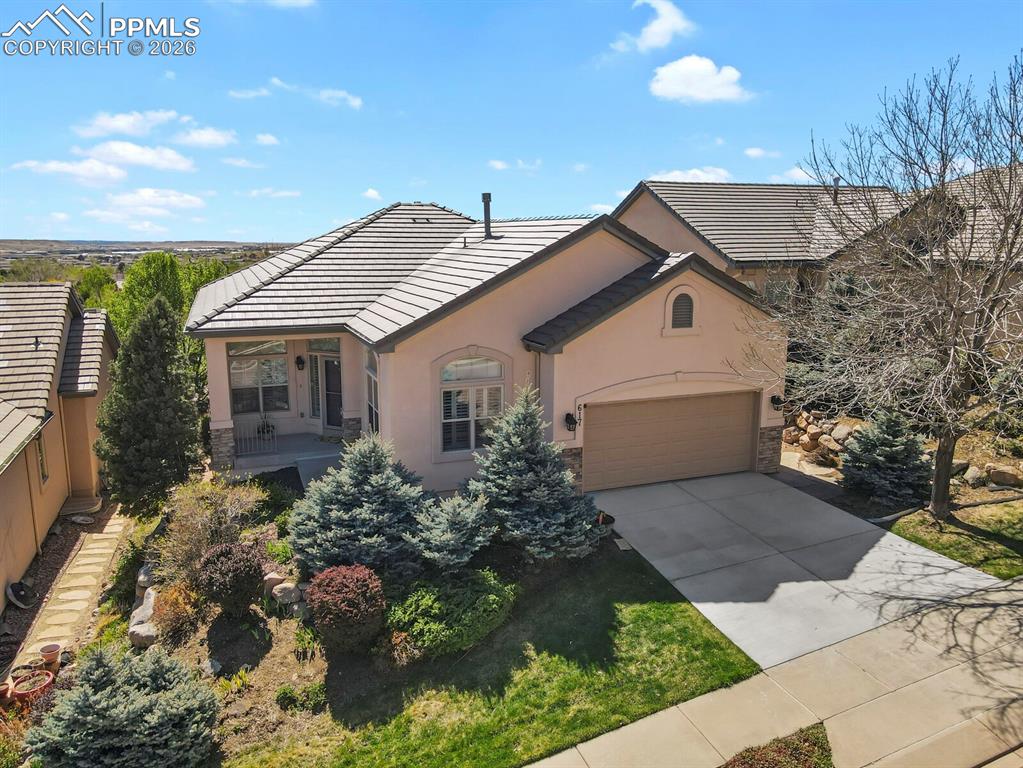 617 Concerto Drive Colorado Springs, CO 80906 - Photo 1 of 46 The property features a well-maintained exterior with a tiled roof and a two-car garage
